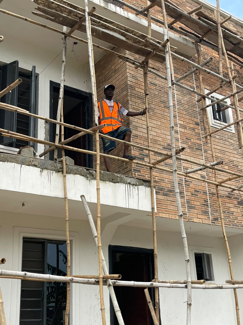 Adolas Construction team member on scaffolding during brickwork finishing